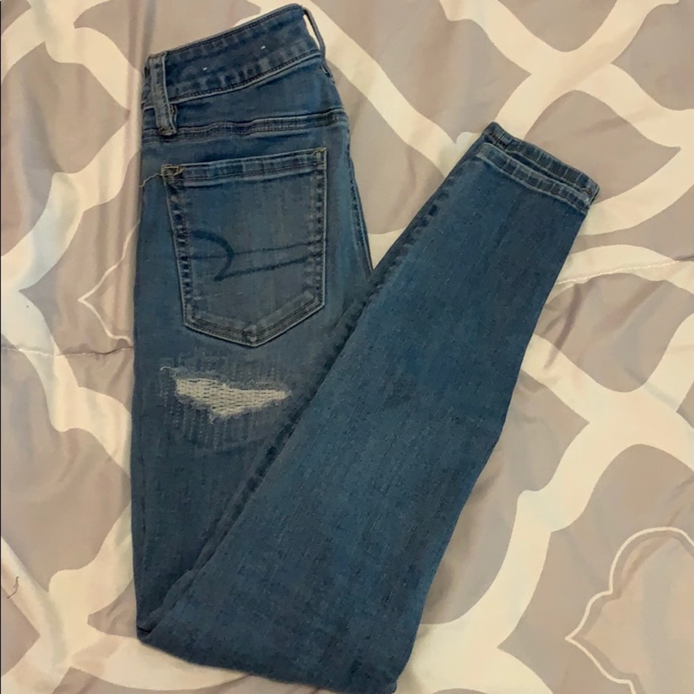 Ripped patched super stretch skinny jeans